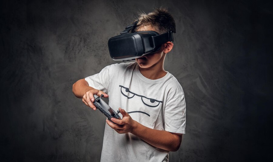 little-trendy-kid-is-playing-new-videogame-using-special-virtual-reality-goggles-joystick_613910-3044